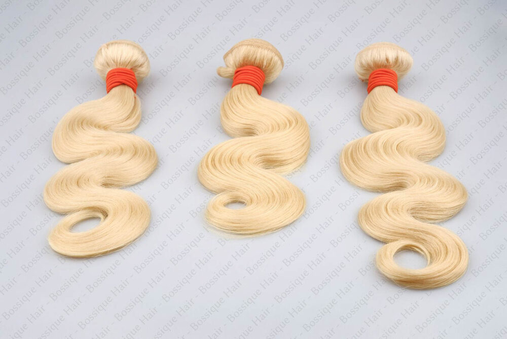 Angled layout of three 613 body wave bundles showing the full density and bounce of the hair from the root to the tip