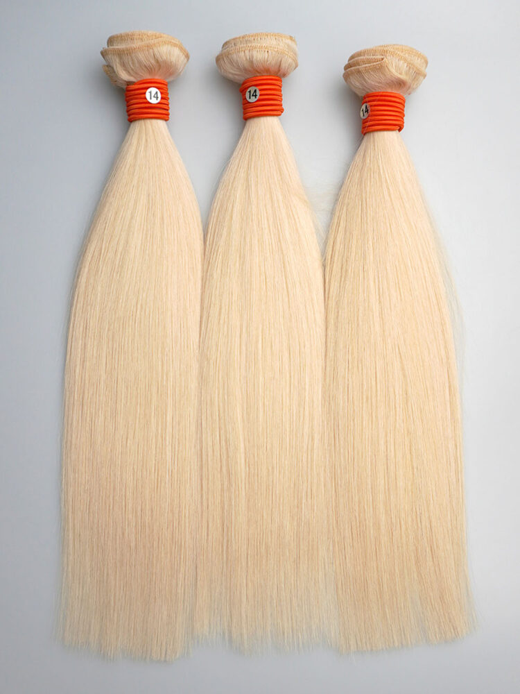 Three 613 straight bundles laid side-by-side displaying their pure, wheat-like blonde color and consistent thickness