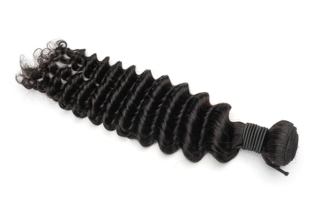 One bundle of deep wave hair on a neutral background.