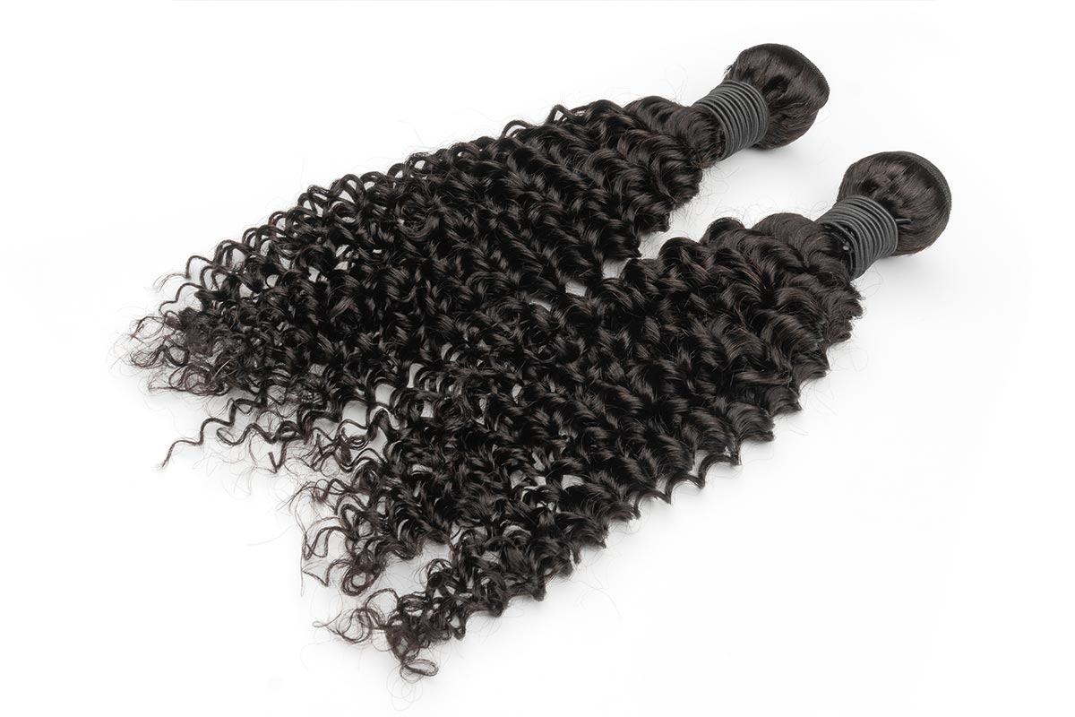Duo of kinky curly human hair bundles laid flat.