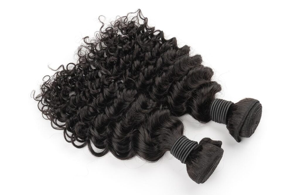Two bundles of Black Line French Curly Hair extensions.