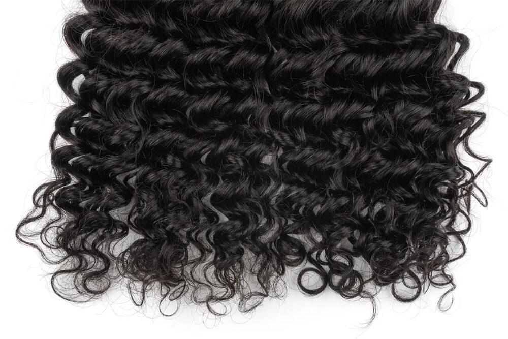 Close-up view of Black Line French Curly Hair extensions.