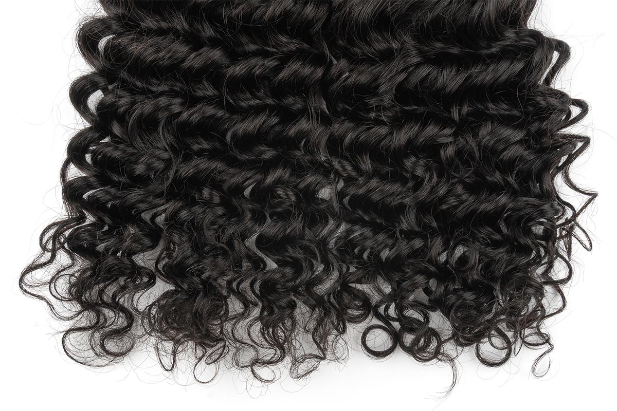 Close-up view of Black Line French Curly Hair extensions.