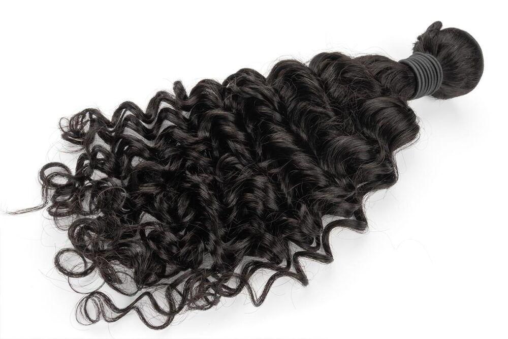 Single bundle of Black Line French Curly Hair laid flat.