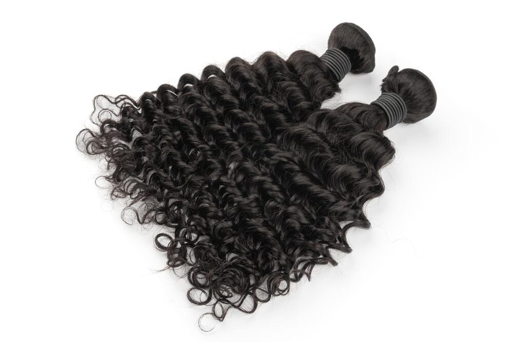 Dynamic view of two French Curly Hair bundles.