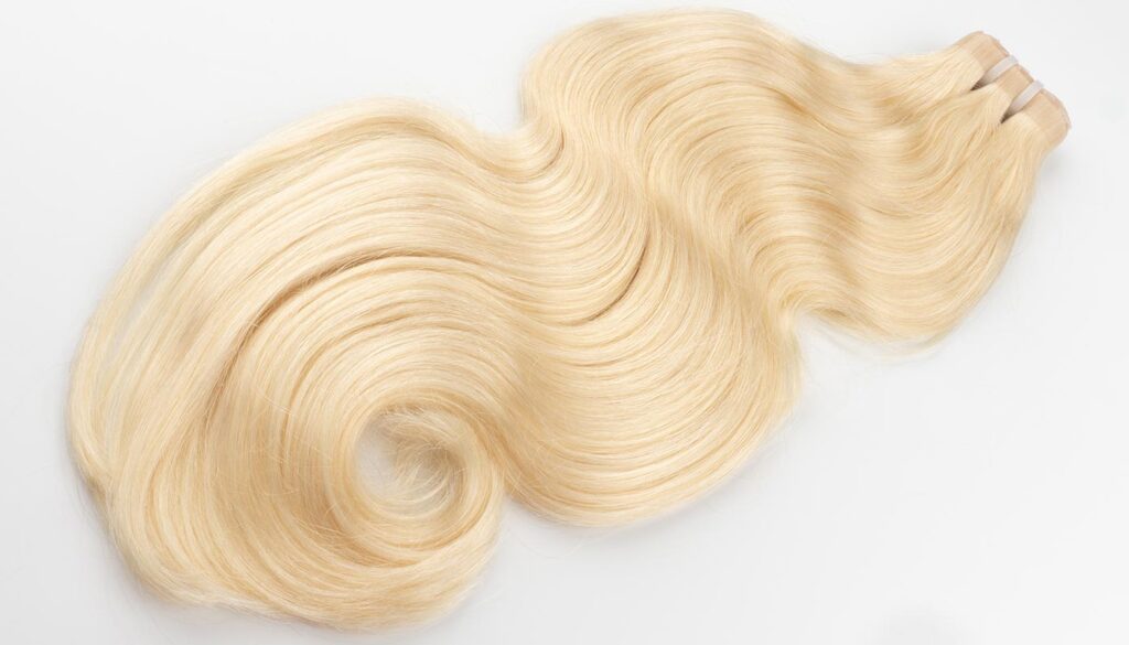 Blonde body wave butterfly wefts with a smooth, wavy texture.