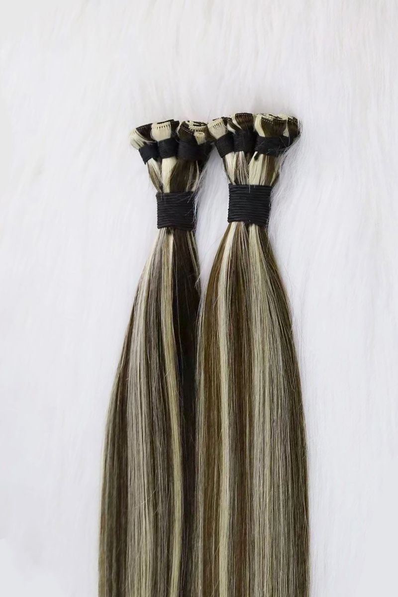 Piano-colored hand-tied weft extensions in blonde and brown.