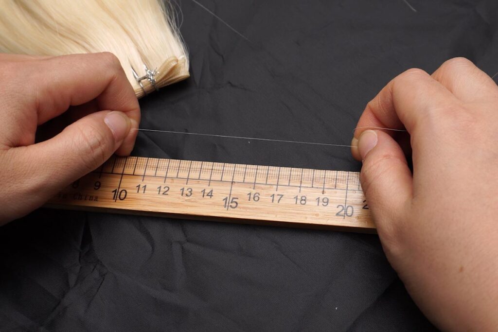 Performing the elasticity test on healthy hair, showcasing its resilience and stretchability.