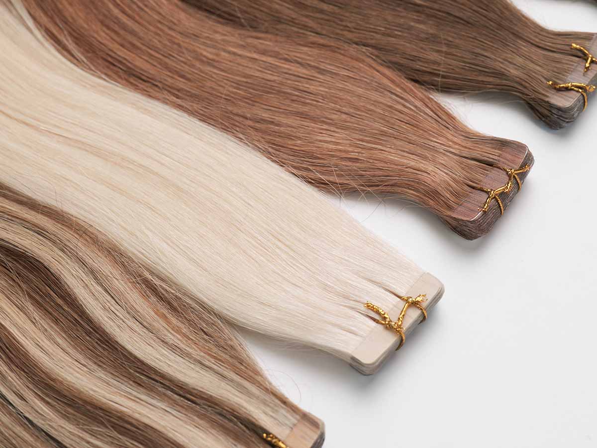 Close-up shot of colored straight tape-in extensions in shades 613 and 30, highlighting color depth.