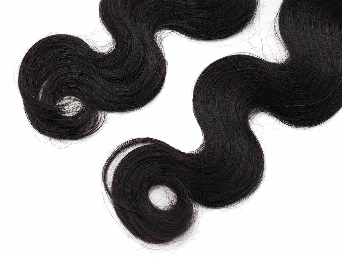 Angled view of the body wave tape-in extension ends, showing wave flow and bundle density.