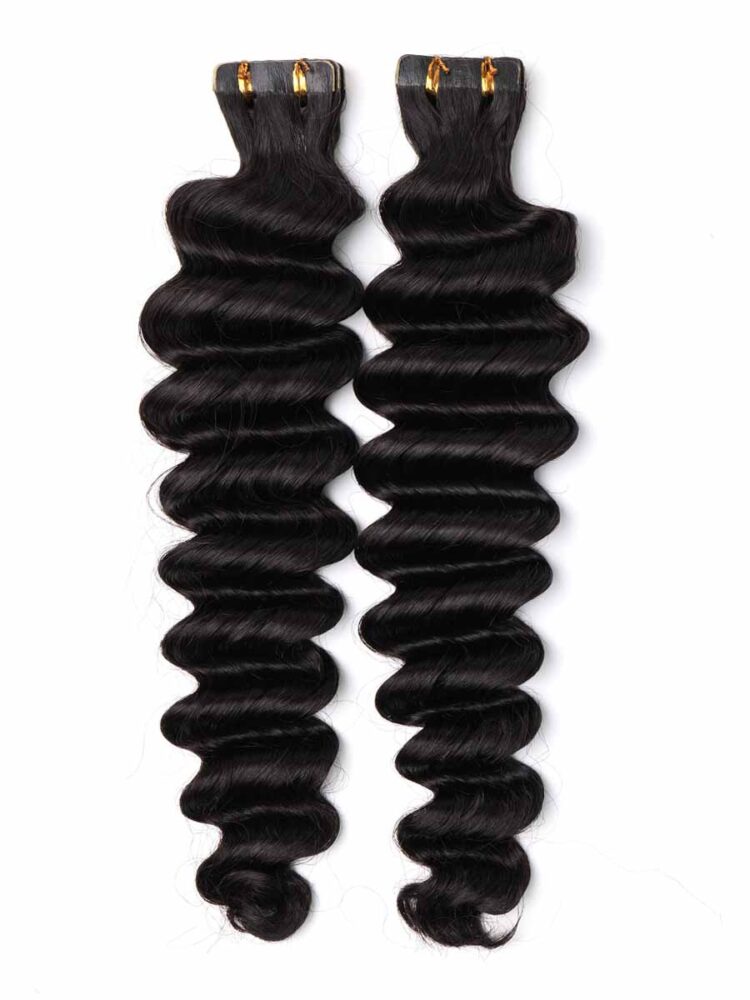 Pair of deep wave tape-in extensions laid on a white background, clearly showing tape tab positioning.