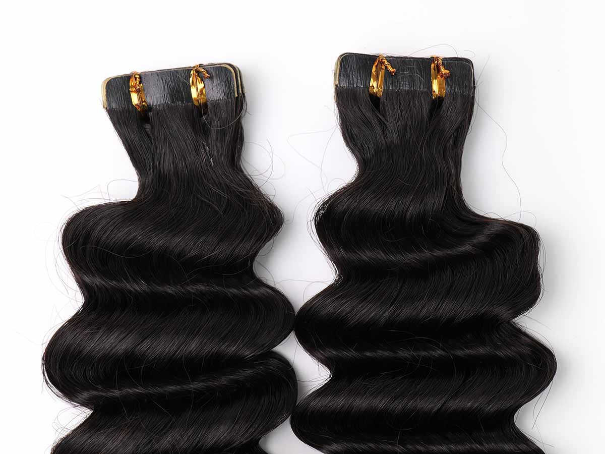 Close-up of the tape section of deep wave tape-in extensions, showing the tabs and attachment points.
