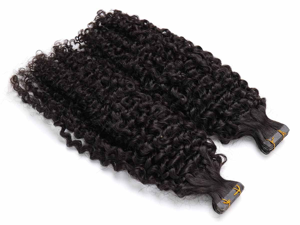Angled view of two jerry curl tape-in extension bundles with tape area facing the camera.