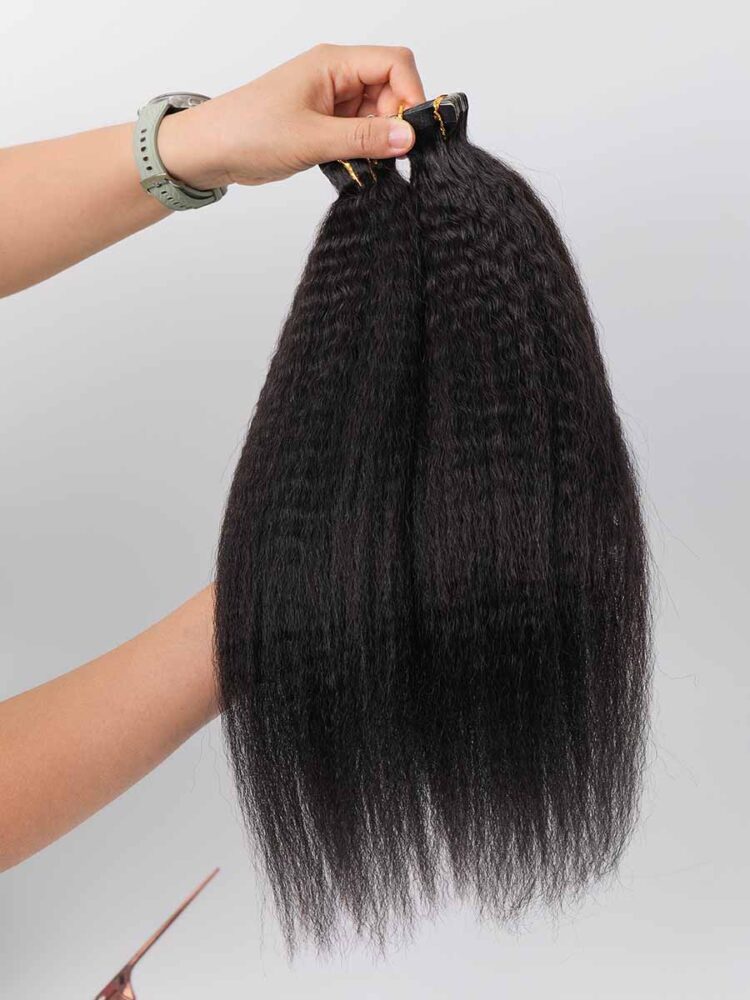 two kinky straight tape-in hair extensions displayed hanging straight down