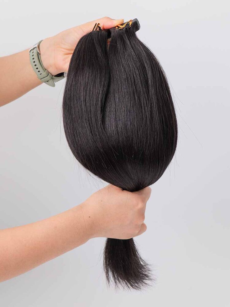 Black Line Straight Tape-In Extensions, 2 pieces, 50g, straight texture under natural light.