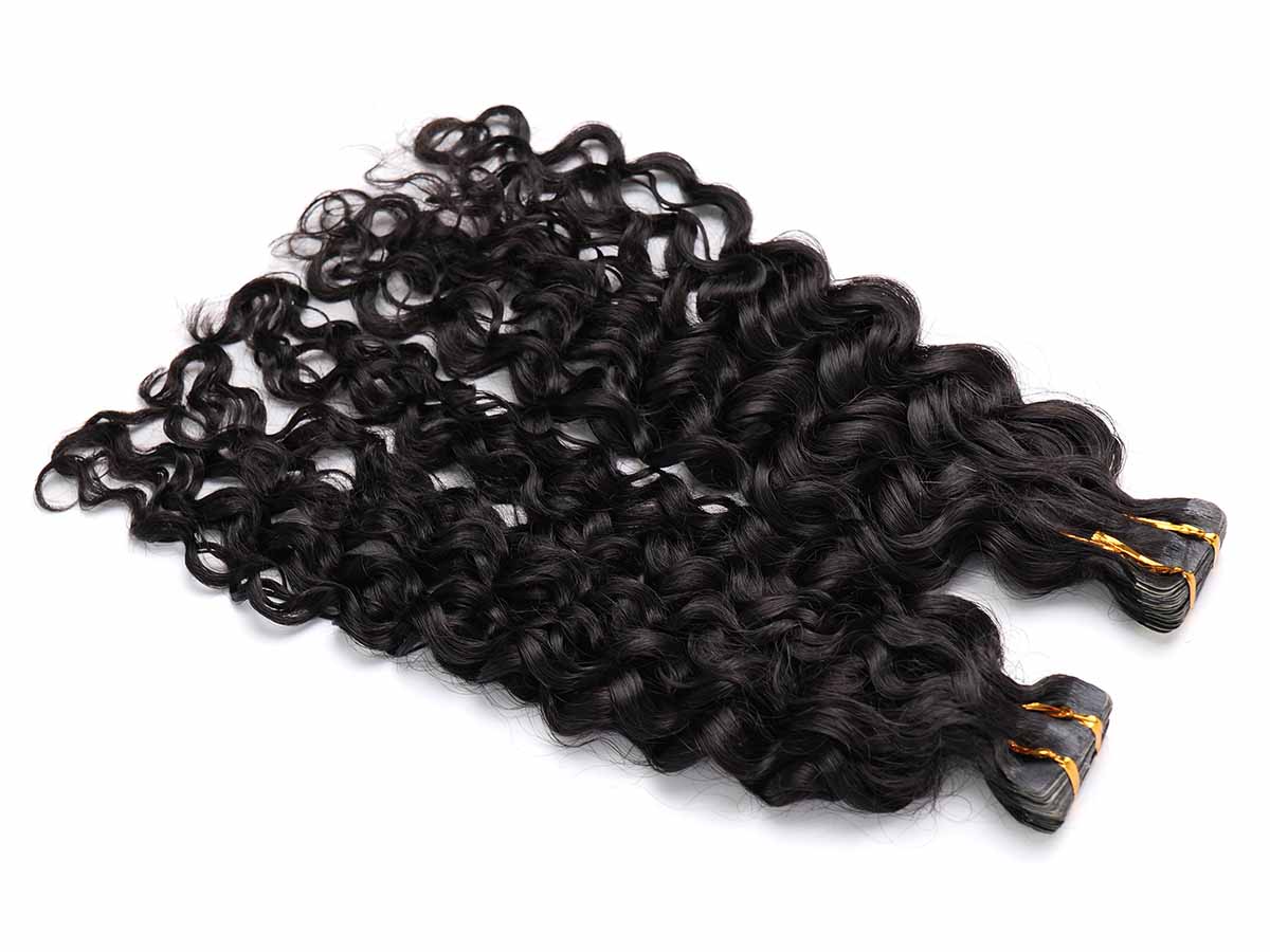 Angled image of water wave tape-in extensions with emphasis on the tape section.