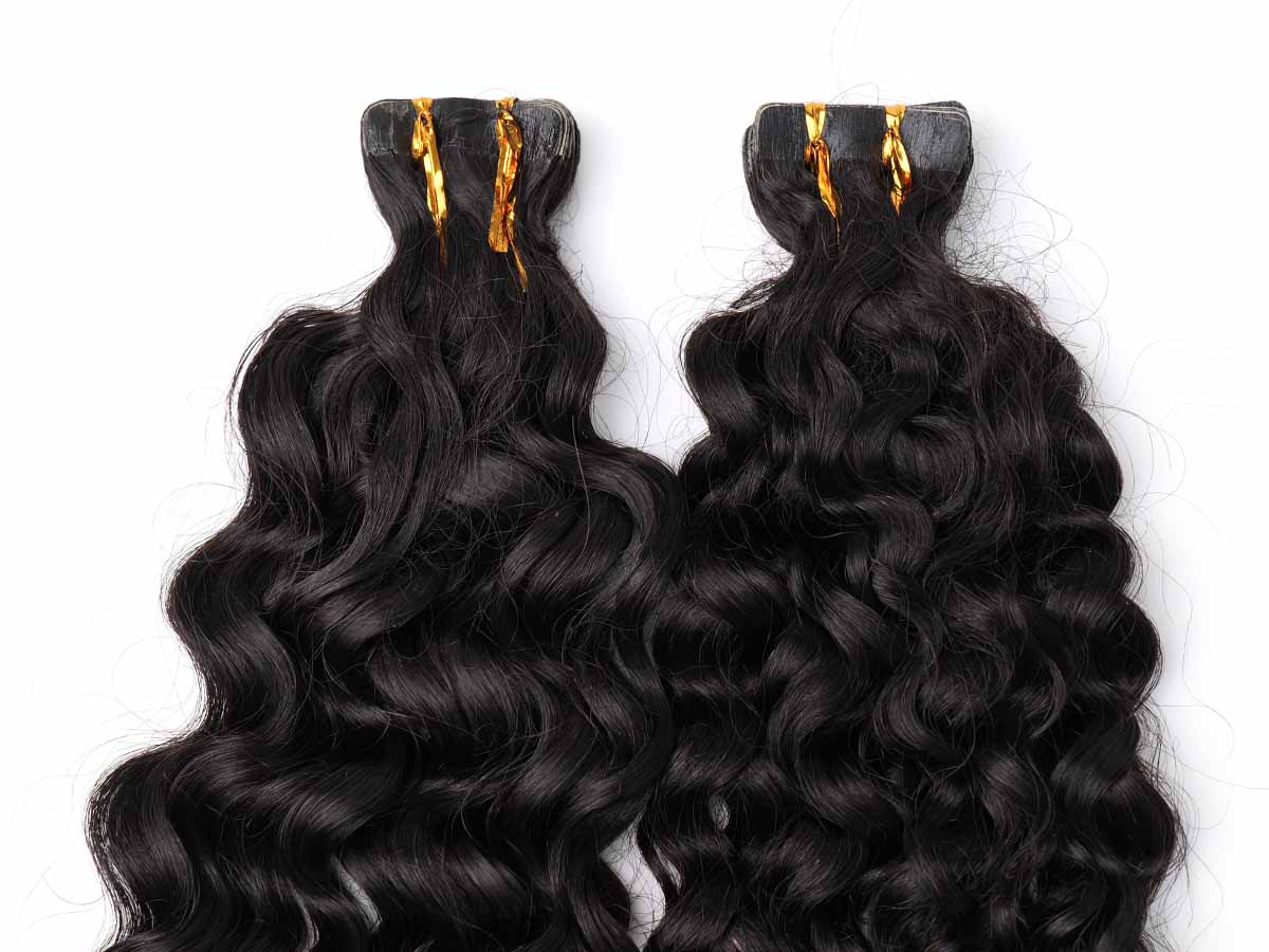 Detail shot of the tape area of water wave tape-in extensions, showing tab layout.